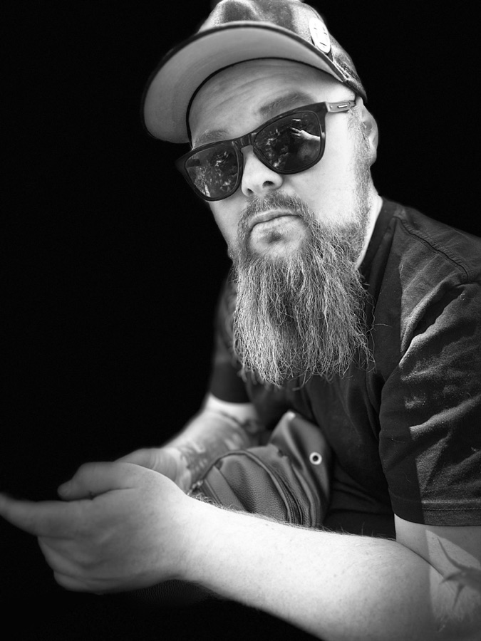 Glyn Simpson in a cap and sunglasses, with a long beard